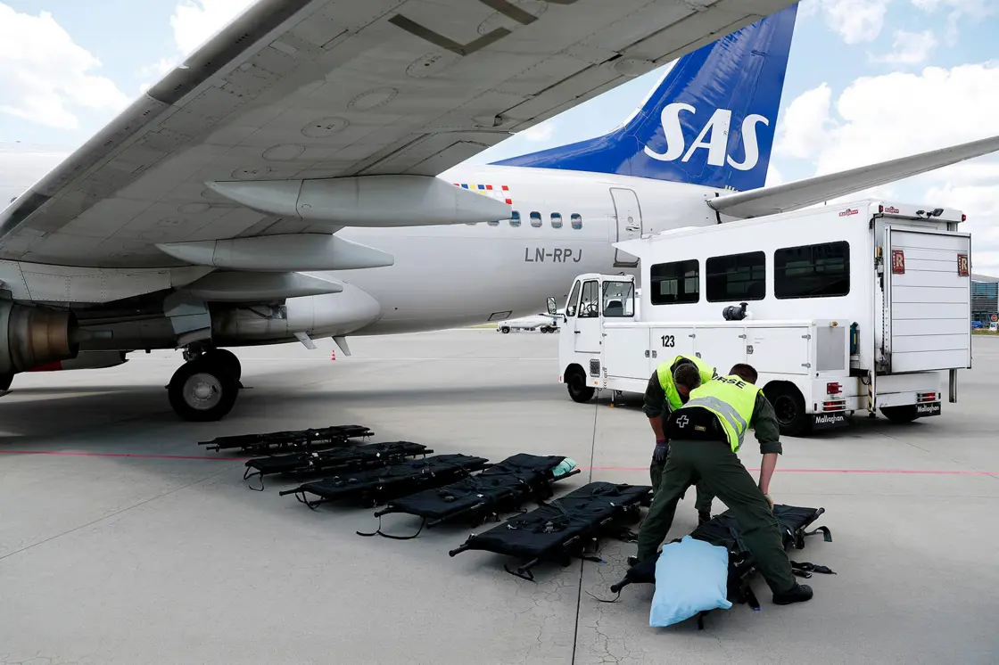 Picture of an aircraft and medical personnell.